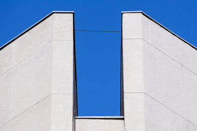 Abstract architectural detail of a concrete office building facade isolated with blue sky background