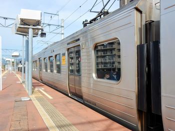 Train at railroad station platform against sky