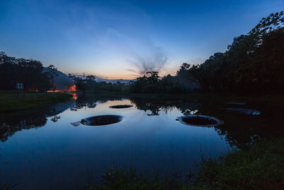 Scenic view of lake against sky at sunset