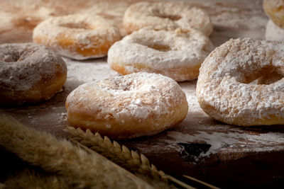 Picture of doughnuts with icing sugar on wooden table,food concept.