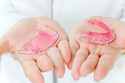 Close-up of dentist holding braces