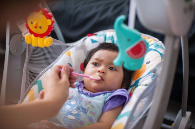 Portrait of cute girl holding toy toys