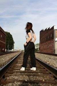 Young woman standing on railroad station