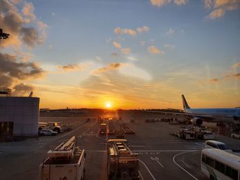 View of airport runway against sky during sunset