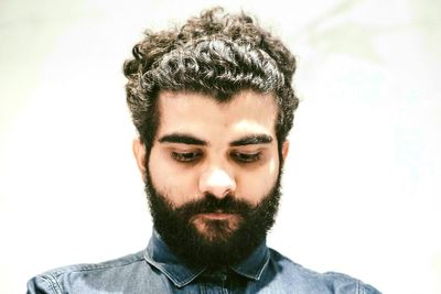 Portrait of young woman against white background