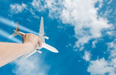 Low angle view of airplane flying against sky