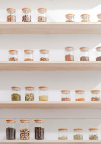 Close-up of bottles on shelf against wall