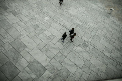 High angle view of friends walking on pedestrian zone