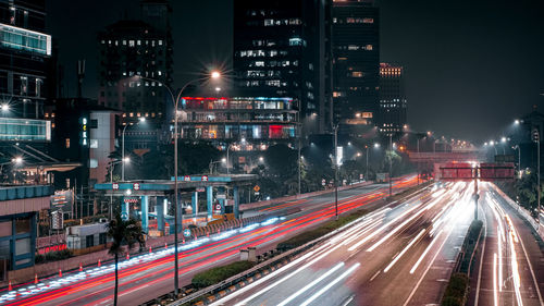 Light trails on road in city at night