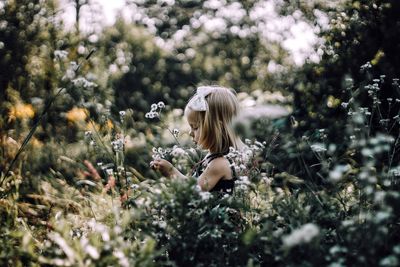 Young woman with flowers on grass