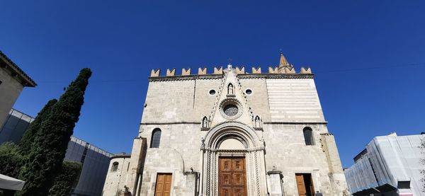 Low angle view of buildings against blue sky