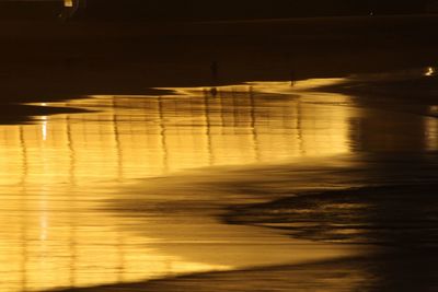 Blurred motion of illuminated bridge at night