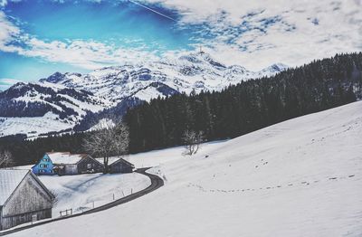 Scenic view of snow covered mountains against sky