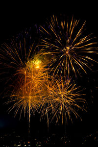 Low angle view of firework display at night