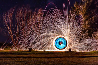 Man standing by wire wool at night