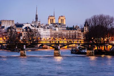 Bridge over river with buildings in background