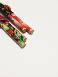 Multi colored pencils over white background