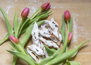 Close-up of tulips and food on table