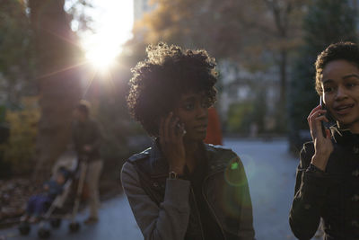 Young women talking on their cell phones