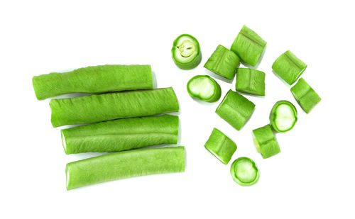 Close-up of green chili pepper against white background