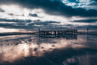 Pier over sea against sky