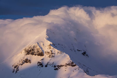 Aerial view of snow covered mountain against sky