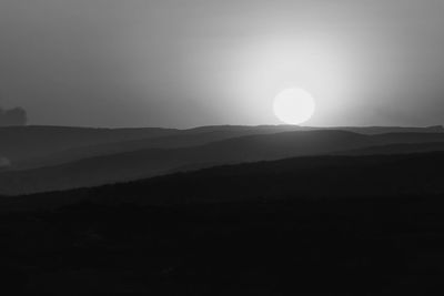 Scenic view of silhouette mountains against sky during sunset