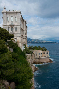 Building by sea against sky