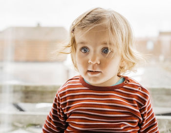 Close-up of cute girl looking away