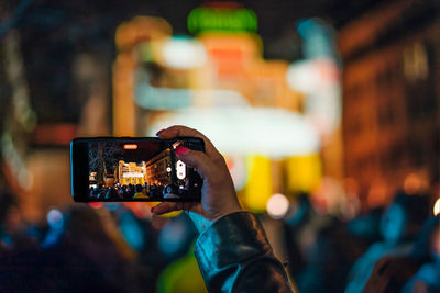 Cropped hand of man using mobile phone