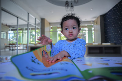 Portrait of smiling girl studying at table