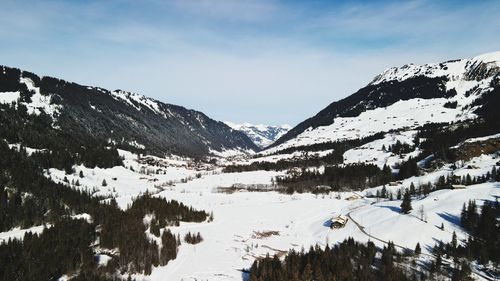 Scenic view of snow covered mountains against sky