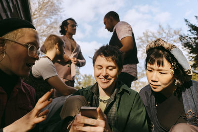 Portrait of smiling friends enjoying at park