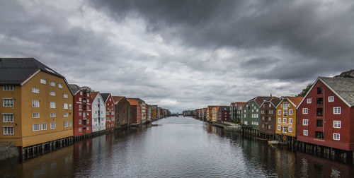 Canal amidst buildings against sky
