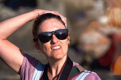 Portrait of young woman wearing sunglasses standing outdoors