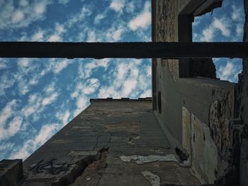 Low angle view of built structure against cloudy sky