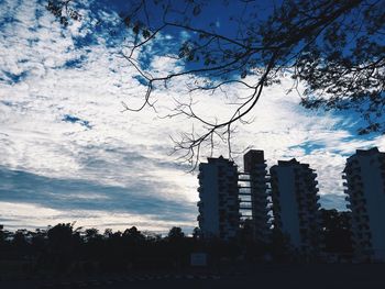 Low angle view of building against cloudy sky