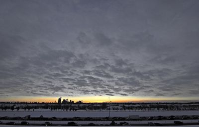 Snow covered landscape at sunset