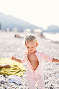 Portrait of young woman standing at beach