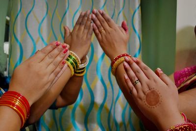 Four women's beautiful hand in namste gesture