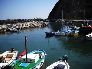 Boats moored on sea against clear sky