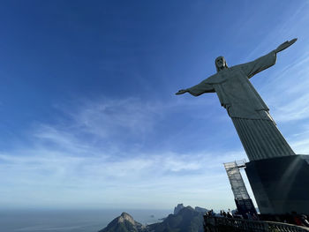 Low angle view of statue against blue sky