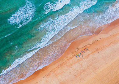 High angle view of people and waves on beach