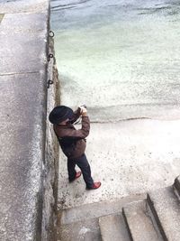 High angle view of man photographing at beach