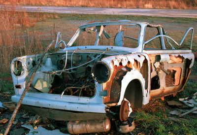 Abandoned vintage car on field
