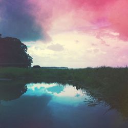Scenic view of lake against sky at sunset