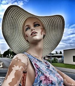 Portrait of young woman looking away against sky