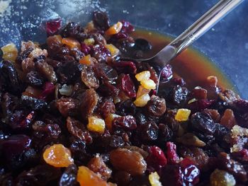 Macro shot of raisin in bowl with spoon