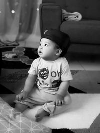 Cute boy looking away while sitting at home