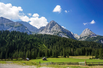 Scenic view of trees and mountains against sky